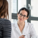 Female physician listening to her patient during consultation